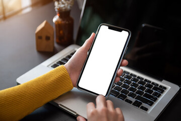 Man holding smartphone with blank screen, close-up of hands. Space for text.