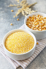 Food gluten free ingredient. Corn groats and seeds over gray stone background.