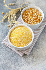 Food gluten free ingredient. Corn groats and seeds over gray stone background. Copy space.