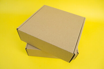 cardboard boxes of various shapes and positions isolated on a yellow background       