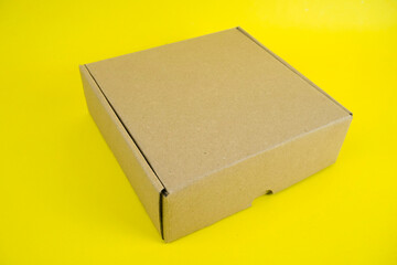 cardboard boxes of various shapes and positions isolated on a yellow background       