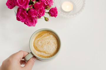 Cup with coffee and pink flowers