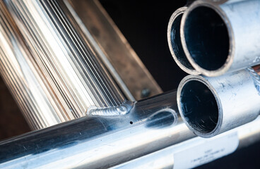 Welded new aluminum pipes close-up.