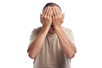 PNG shot of a mature man standing against a grey background in the studio and covering his face with his hands
