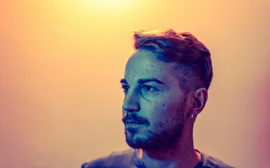 led colors photo portrait with copy space of proud caucasian young man looking away