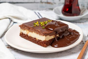 Chocolate cake slice. Chocolate and cream cake on wood floor background. close up