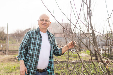 Elderly farmer in the garden in spring season