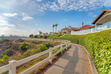 Concrete trail with white wooden railings at Southern California