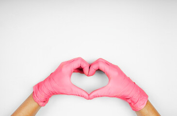 Hands in heart-shaped medecine gloves color viva magenta