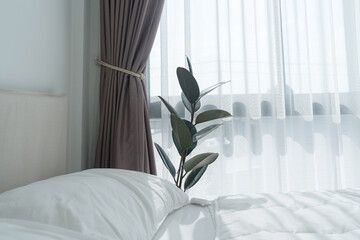 Fototapeta na wymiar White bedroom with white curtains and white pillows