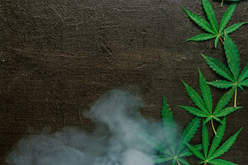 green leaves of marijuana, medicinal hemp in smoke from smoking on black  background 3
