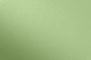 Soft plain pale soft leafy green color paint gradation on recycled cardboard box blank paper texture minimal background with space