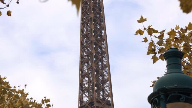 Detail of the Eiffel Tower with an elevator going up on an autumn day in Paris, France
