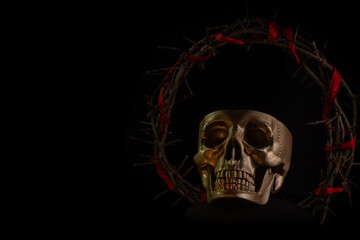 Skull of a person with crown of thorns close up on a black background