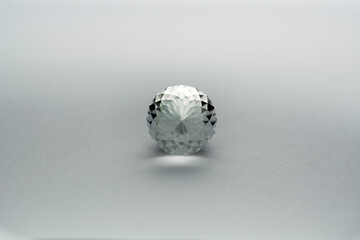 Briolette faceted natural colorless white topaz unheated gemstone. Bottom view. Monochrome gray...