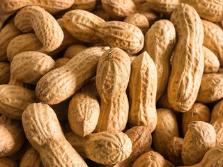 Fototapeta premium Close-up of a pile of peanuts (Arachis hypogaea), legume, unpeeled, full frame