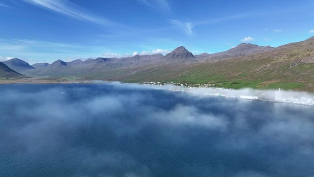 Idyllic Faskrudsfjordur Fjord With Low Clouds In East Iceland  - aerial drone shot