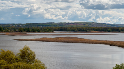 River landscape with islands and cloudy sky in the background