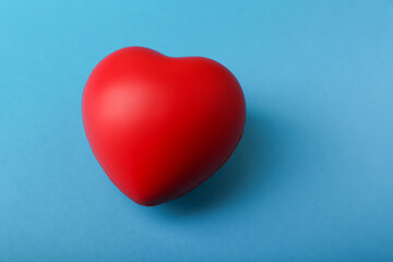 red heart is on blue background top view