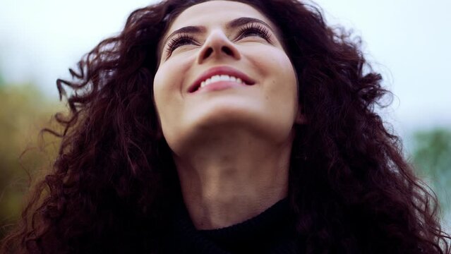 Faithful Contemplative happy woman face looking up at sky feeling the presence of the divine