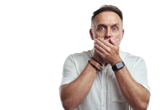 PNG studio portrait of a mature man covering his mouth and looking shocked against a grey background