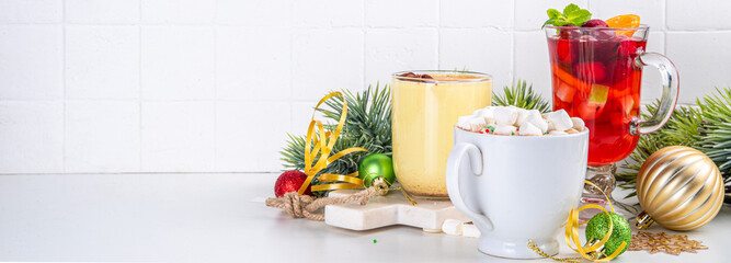 Set of traditional Christmas winter drinks. Christmas bar menu background.Tree cup with mulled wine, eggnog, hot chocolate beverages om white table with Christmas, New Year decorations, copy space