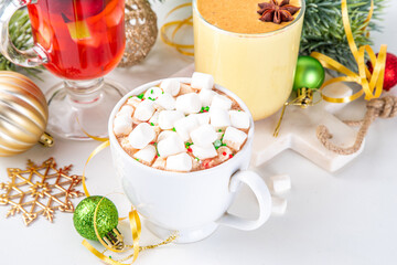 Set of traditional Christmas winter drinks. Christmas bar menu background.Tree cup with mulled wine, eggnog, hot chocolate beverages om white table with Christmas, New Year decorations, copy space