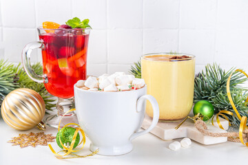 Set of traditional Christmas winter drinks. Christmas bar menu background.Tree cup with mulled wine, eggnog, hot chocolate beverages om white table with Christmas, New Year decorations, copy space