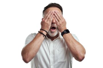 PNG studio shot of a mature man covering his eyes and looking shocked against a grey background