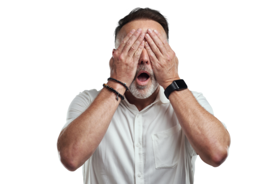 PNG studio shot of a mature man covering his eyes and looking shocked against a grey background - Powered by Adobe
