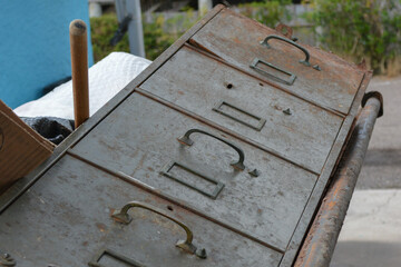 rusty metal locked filing cabinet in a dumpster