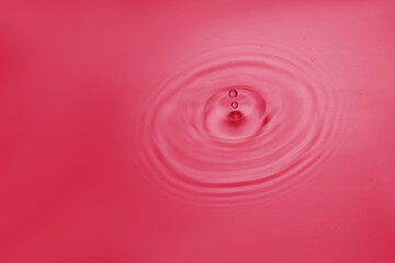 Viva magenta water ripple and water drop. Concept poster of color of the year 2023.