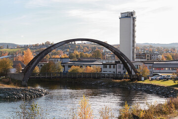 Concrete industrial tower and arch bridge. Norway