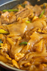 Thai food (Pad See Ew), Cooking Stir fried rice noodles with soy sauce on frying pan 
