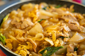 Thai food (Pad See Ew), Cooking Stir fried rice noodles with soy sauce on frying pan 