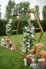 Wedding ceremony. Very beautiful and stylish hexagonal wedding arch, decorated with various fresh...