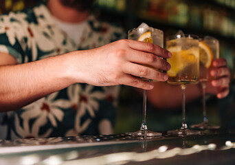 bartender making cocktail glass in bar
