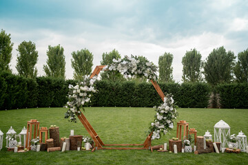 Wedding ceremony. Very beautiful and stylish hexagonal wedding arch, decorated with various fresh...