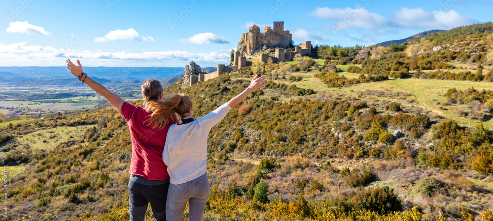 Wall mural traveler couple looking at loarre castle- aragon in spain