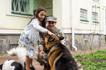 military father meeting with daughter and dogs