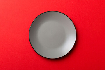 Top view of isolated of colored background empty round gray plate for food. Empty dish with space for your design