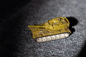 Toy tank with camouflage color. Military vehicles toy. Simple cheap toys for children, warfare, warzone vehicles