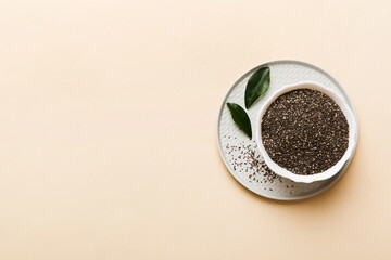 Chia seeds in bowl on colored background. Healthy Salvia hispanica in small bowl. Healthy superfood