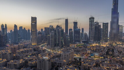 Obraz premium Dubai's business bay towers aerial day to night timelapse. Rooftop view of some skyscrapers