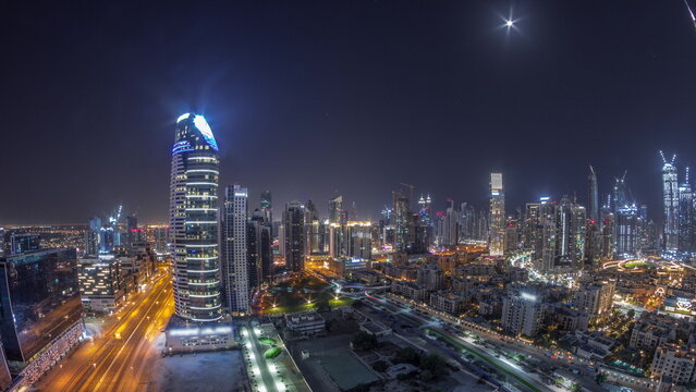 Dubai's business bay towers aerial all night timelapse. Rooftop view of some skyscrapers