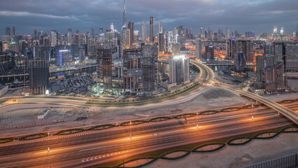 Panoramic skyline of Dubai with business bay and downtown district night to day timelapse.