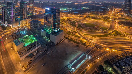 Fototapeta premium Aerial view of media city and al barsha heights district area night to day timelapse from Dubai marina.