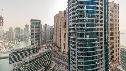 Panorama showing overview to JBR and Dubai Marina skyline with modern high rise skyscrapers waterfront living apartments aerial timelapse