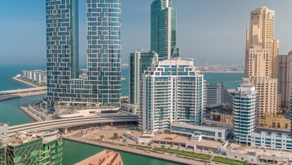 Promenade and canal seen from Dubai marina timelapse. Aerial view to JBR district and Bluewaters Island behind