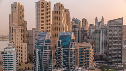 Fototapeta na wymiar Dubai Marina skyscrapers and JBR district with luxury buildings and resorts aerial timelapse